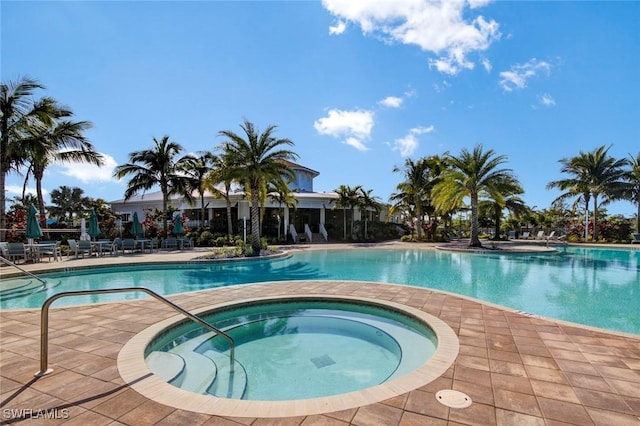 view of pool featuring a patio area and a hot tub