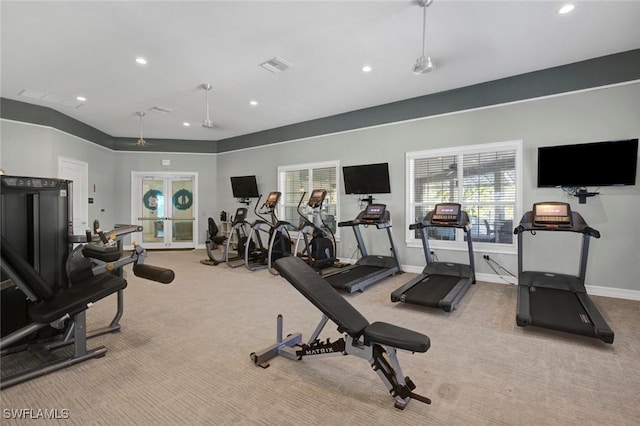 exercise room featuring light colored carpet and french doors