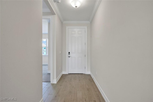 hall with light hardwood / wood-style flooring and ornamental molding