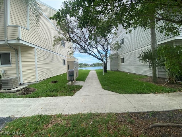 view of home's exterior with a yard and central AC