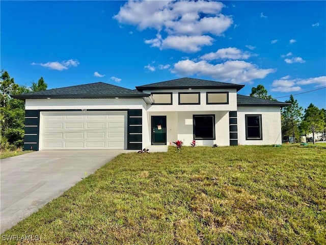 prairie-style home featuring a garage and a front lawn