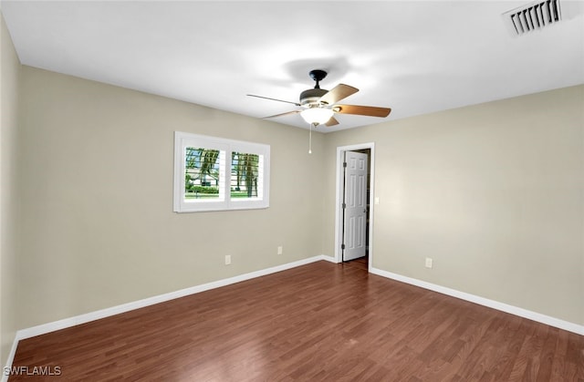 empty room with dark wood-type flooring and ceiling fan