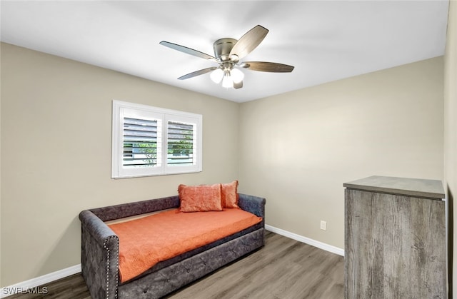 sitting room with ceiling fan and dark hardwood / wood-style flooring