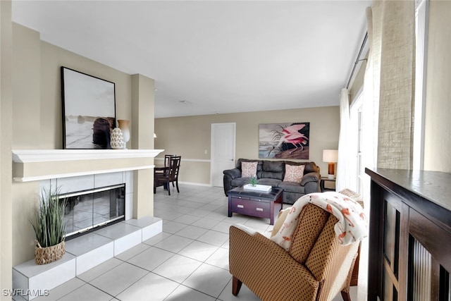 living room with a tile fireplace and light tile patterned floors