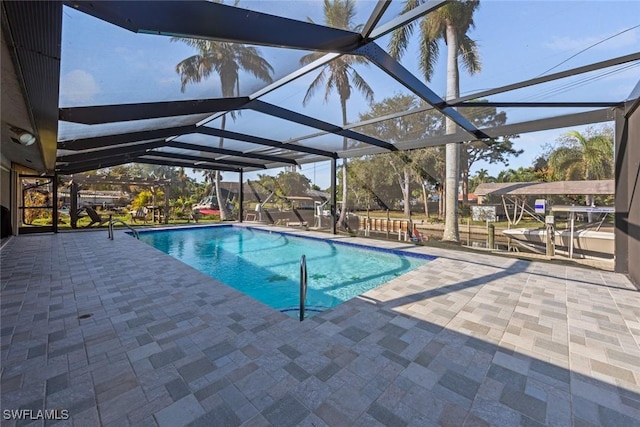 view of pool with a patio and glass enclosure