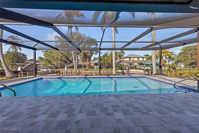 view of swimming pool with a lanai and a patio