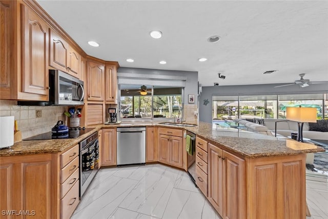 kitchen with stainless steel appliances, backsplash, and light stone counters