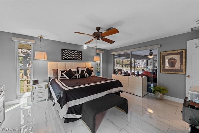 bedroom featuring multiple windows and ceiling fan