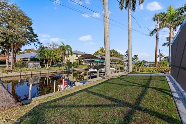 view of yard featuring a water view and a dock