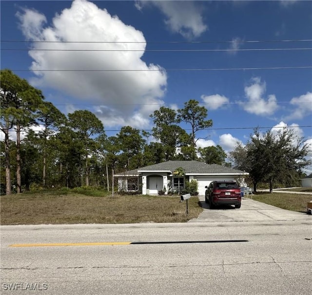 view of front facade with a garage and a front lawn