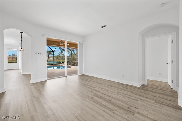 empty room featuring a wealth of natural light and light hardwood / wood-style flooring