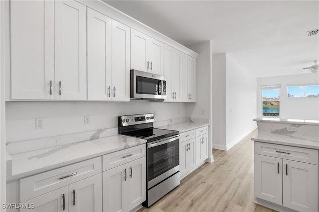 kitchen featuring white cabinetry, ceiling fan, stainless steel appliances, light stone countertops, and light hardwood / wood-style floors