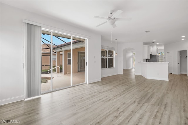 unfurnished living room featuring ceiling fan and light hardwood / wood-style flooring