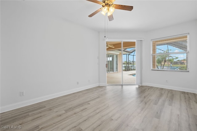 empty room featuring ceiling fan and light hardwood / wood-style flooring