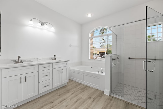 bathroom featuring vanity, shower with separate bathtub, and hardwood / wood-style floors