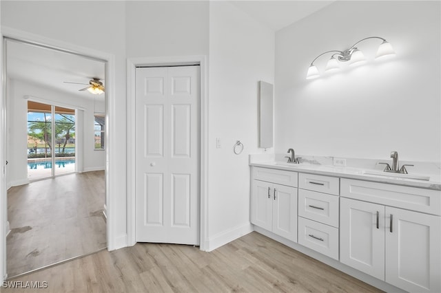 bathroom with ceiling fan, vanity, and hardwood / wood-style floors