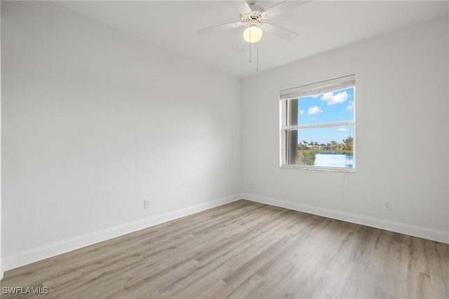 spare room featuring ceiling fan and light wood-type flooring