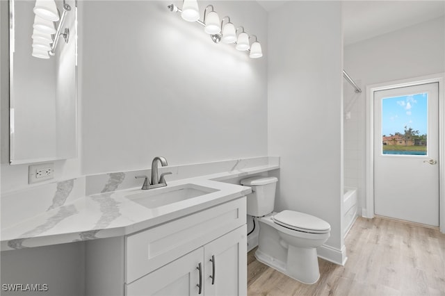 full bathroom with vanity, hardwood / wood-style flooring, toilet, and shower / bath combination