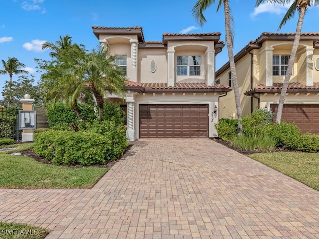 mediterranean / spanish-style house with a garage