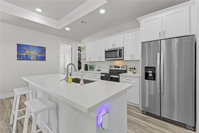 kitchen with appliances with stainless steel finishes, sink, and white cabinets