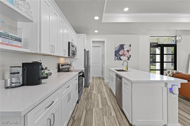 kitchen with white cabinetry, sink, stainless steel appliances, and light hardwood / wood-style floors