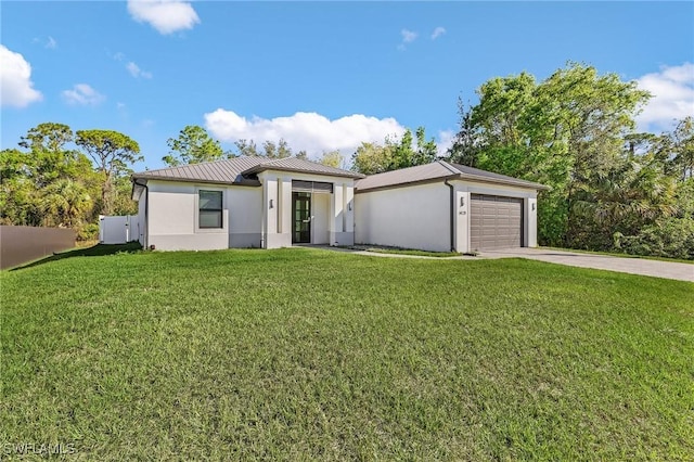 view of front of house featuring a garage and a front lawn