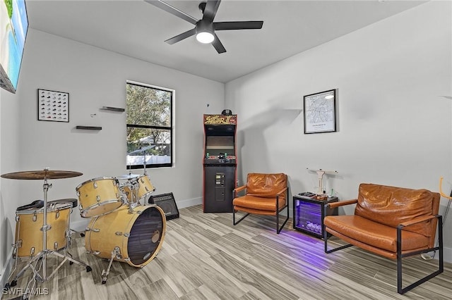 living area featuring ceiling fan and light hardwood / wood-style floors