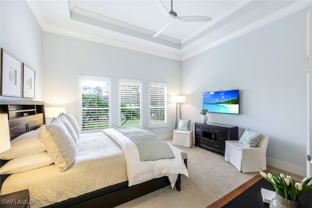 bedroom featuring ornamental molding, a raised ceiling, ceiling fan, and light wood-type flooring