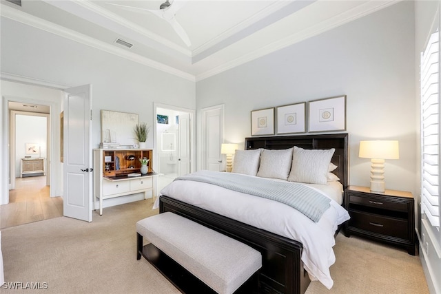 carpeted bedroom featuring ornamental molding, a towering ceiling, ensuite bathroom, and a tray ceiling