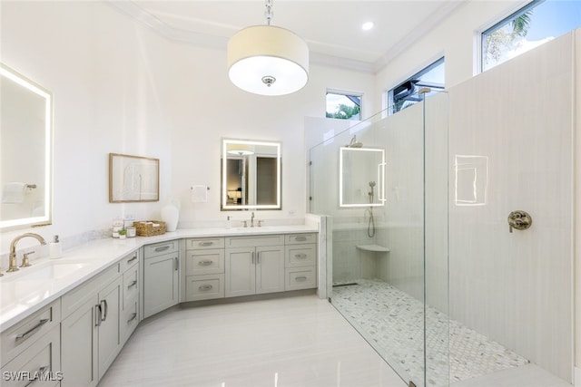 bathroom with vanity, ornamental molding, and tiled shower