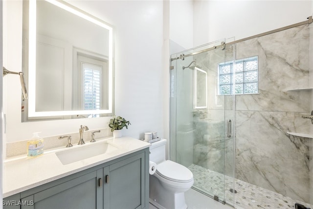 bathroom with vanity, plenty of natural light, and walk in shower