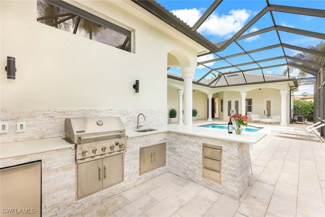 view of patio / terrace with area for grilling, sink, and glass enclosure