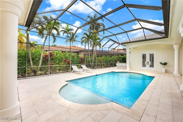 view of pool with a lanai, a patio area, and french doors