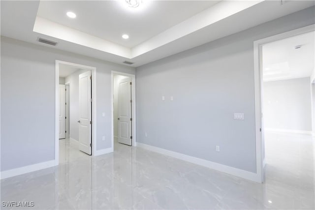 unfurnished bedroom featuring a tray ceiling