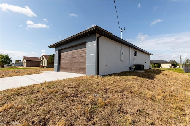 view of home's exterior with a yard, a garage, and central air condition unit