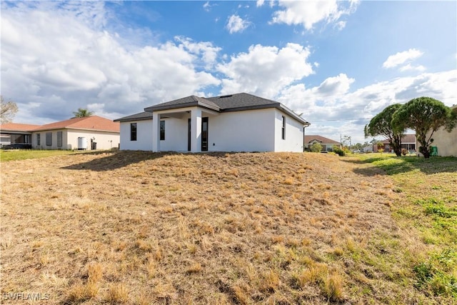 rear view of house featuring a yard