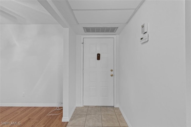 doorway to outside with light tile patterned floors