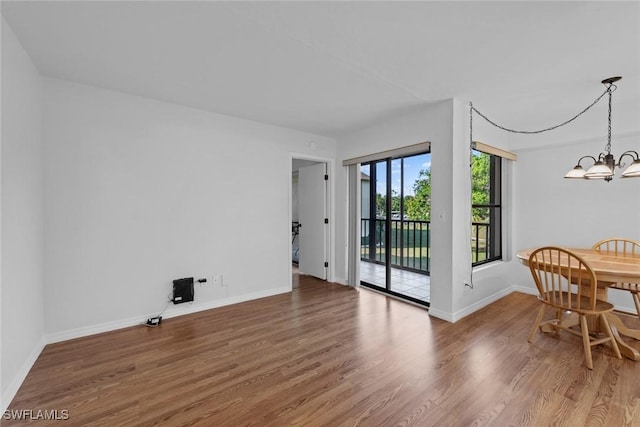 interior space with hardwood / wood-style flooring and a notable chandelier