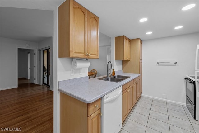 kitchen with sink, light brown cabinetry, white dishwasher, and black electric range oven