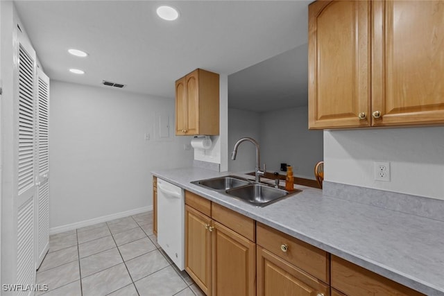 kitchen with light tile patterned flooring, white dishwasher, and sink