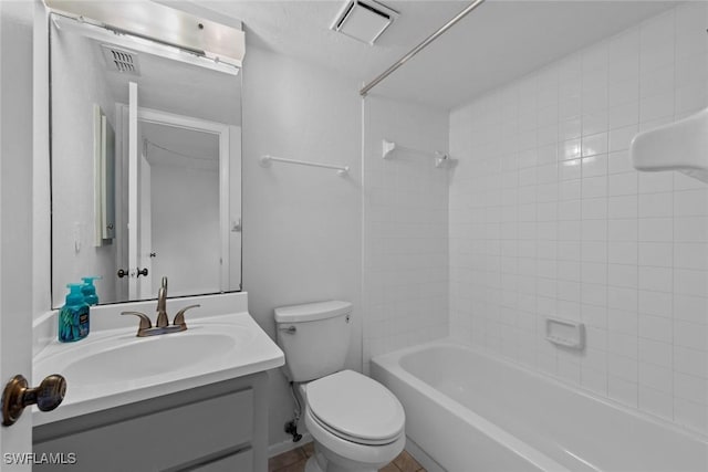 full bathroom with tiled shower / bath combo, vanity, and toilet