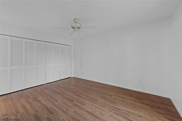 unfurnished bedroom featuring a closet, ceiling fan, and light hardwood / wood-style flooring