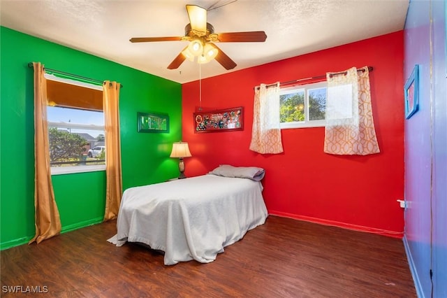 bedroom featuring ceiling fan and dark hardwood / wood-style floors