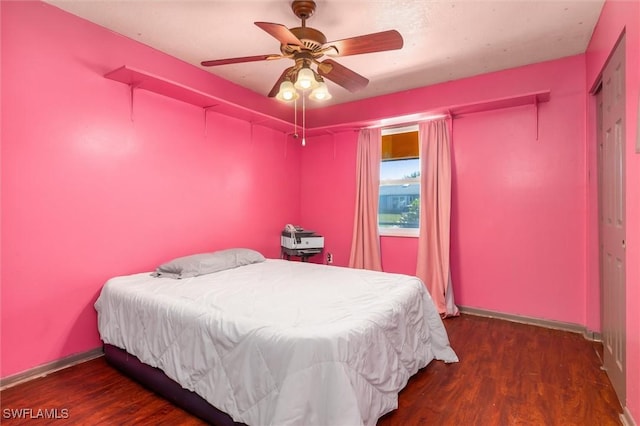 bedroom featuring ceiling fan and dark hardwood / wood-style floors