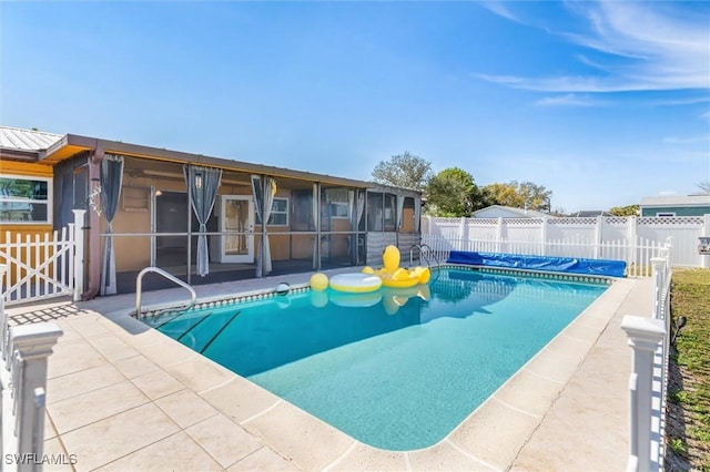 view of pool featuring a sunroom and a patio area