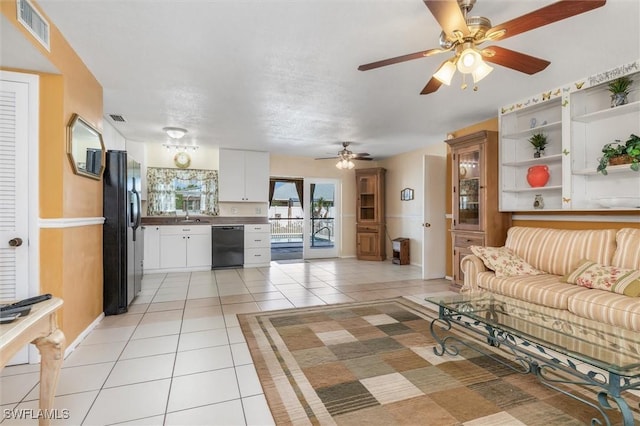 tiled living room featuring sink and ceiling fan