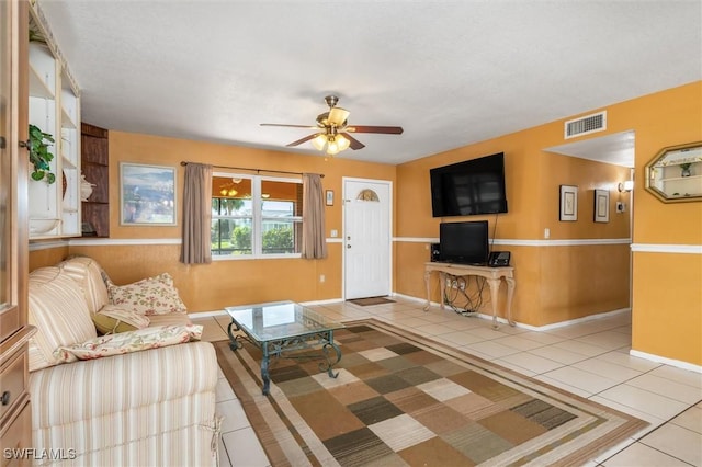 tiled living room featuring ceiling fan