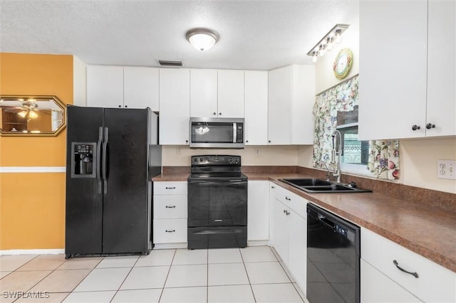 kitchen with white cabinetry, sink, black appliances, and light tile patterned flooring