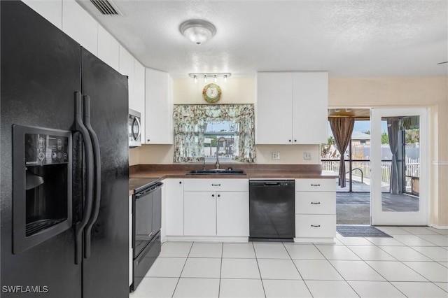 kitchen with sink, white cabinets, and black appliances