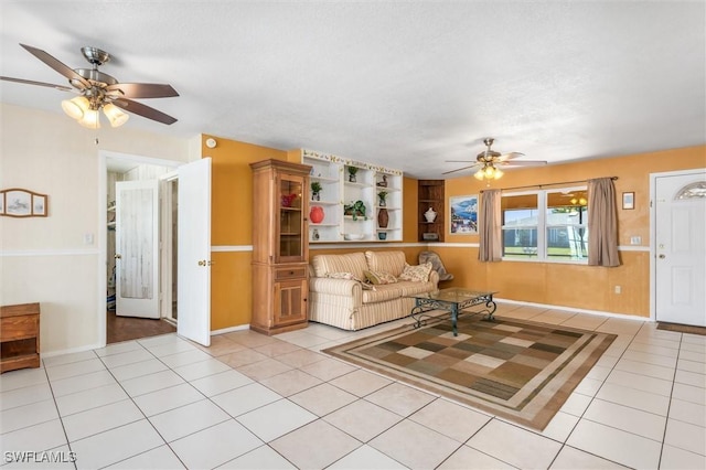 unfurnished living room with light tile patterned flooring and ceiling fan